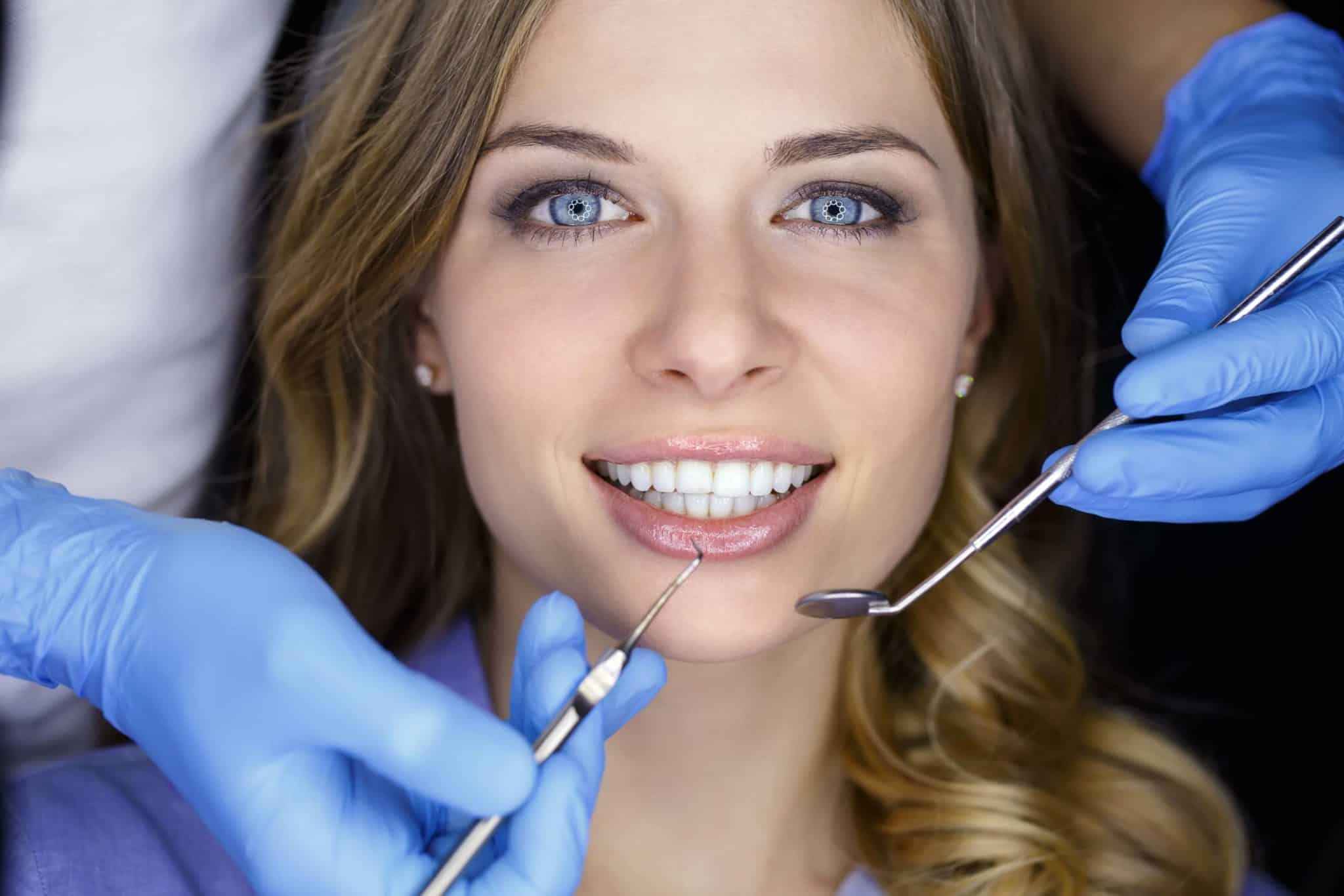 Women in a dentist chair smiling